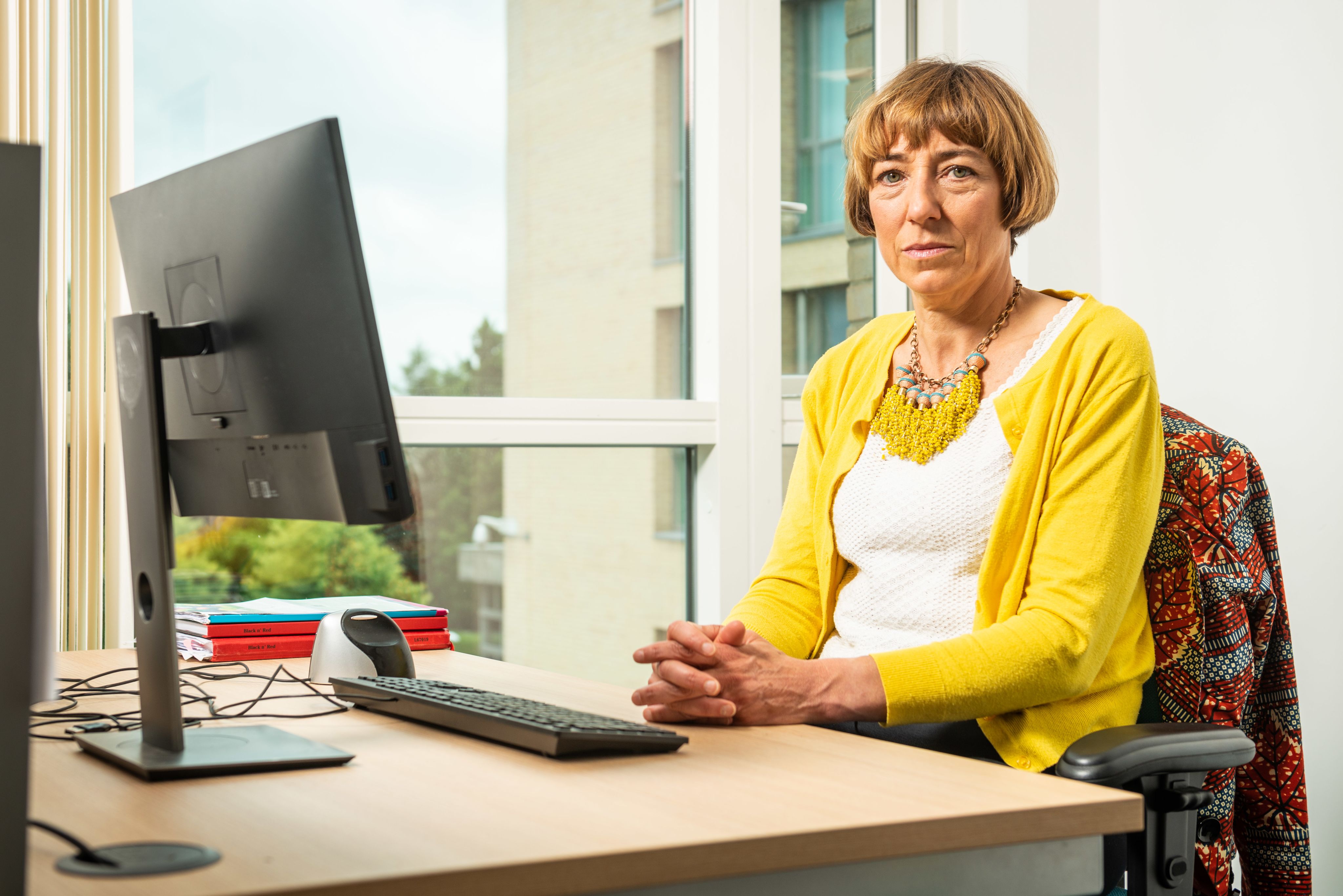 Professor Anna Gilmore at desk.