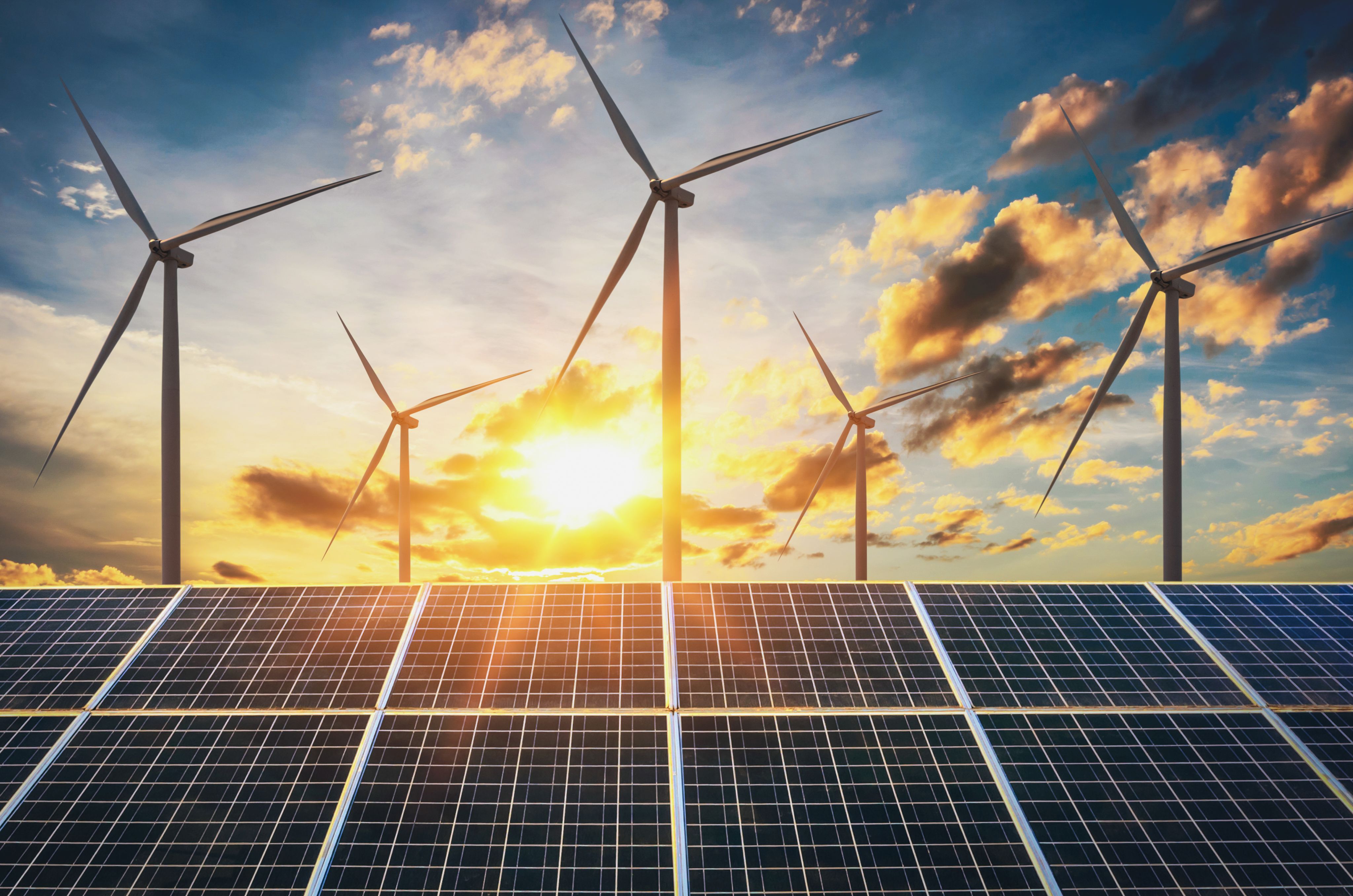 Solar panels and wind turbines in a sunny sky. Credit: Adobe Stock / papan saenkutrueang