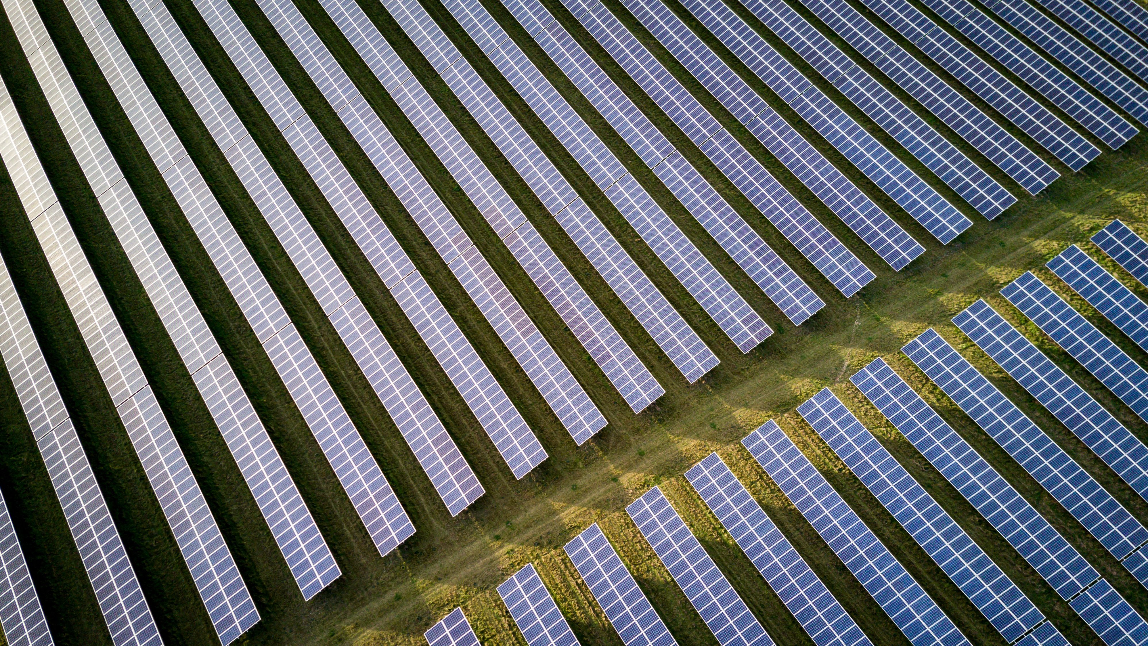 Aerial view of solar farm in UK countryside. Credit: Adobe Stock / pxl.store