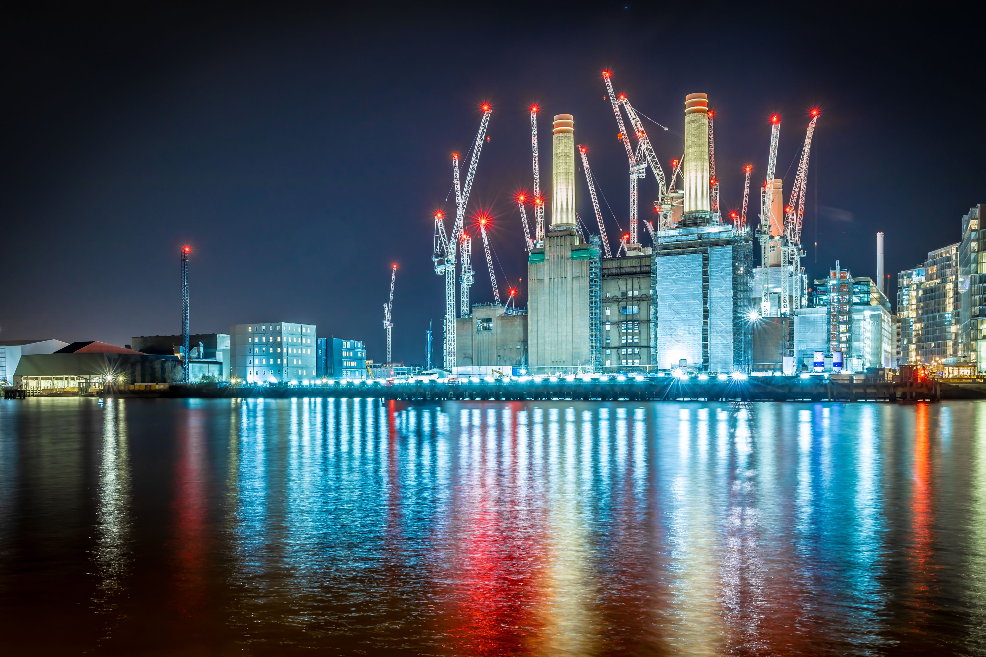 Battersea Power Station building site illuminated at night. Credit: Adobe Stock / Alexey Fedorenko