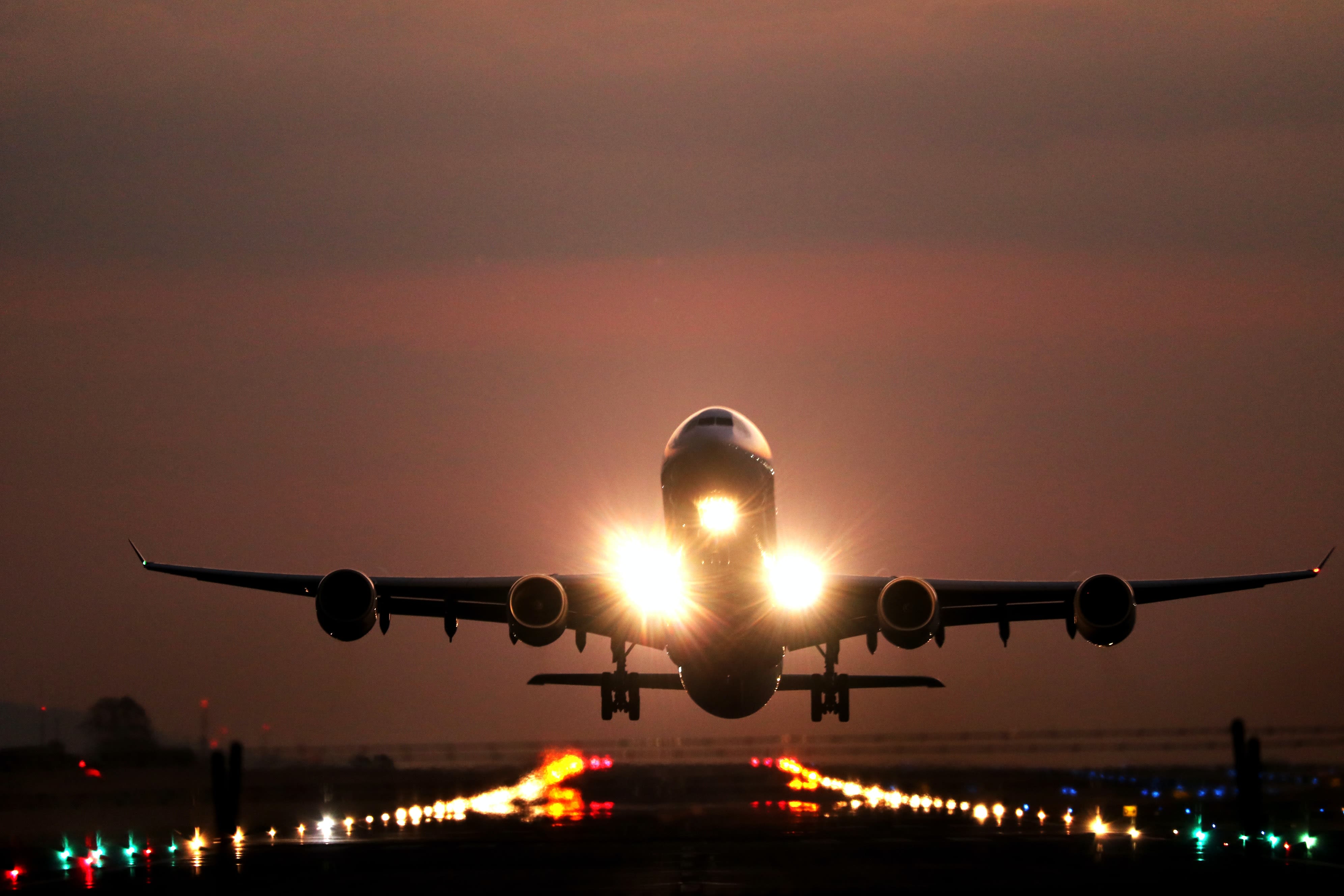 A photo of an airliner landing at night