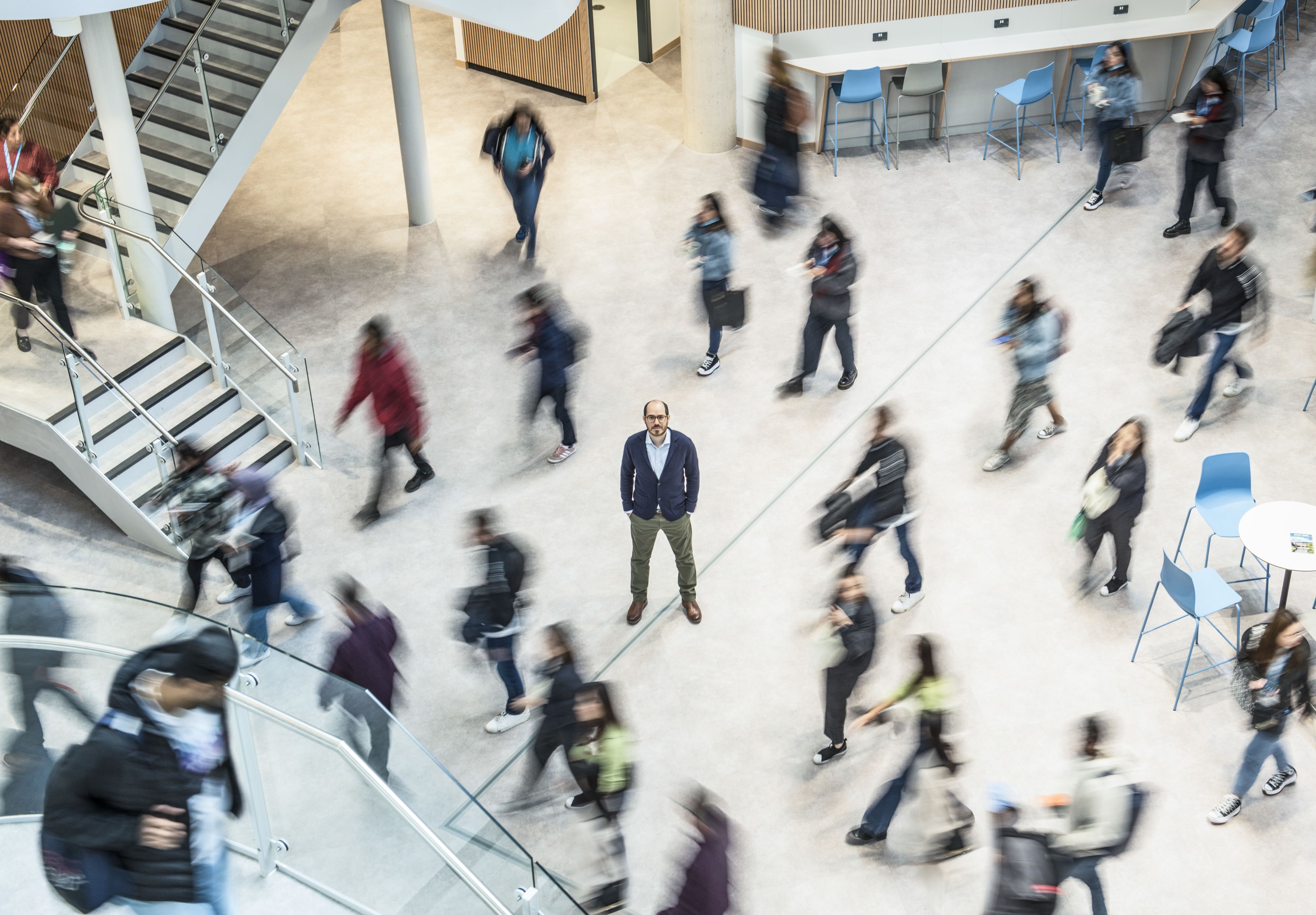 A photograph of Dr Vaggelis Giannikas standing by the columns outside the School of Management building at the University of Bath