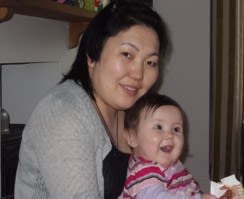 Young child sits on a woman's lap