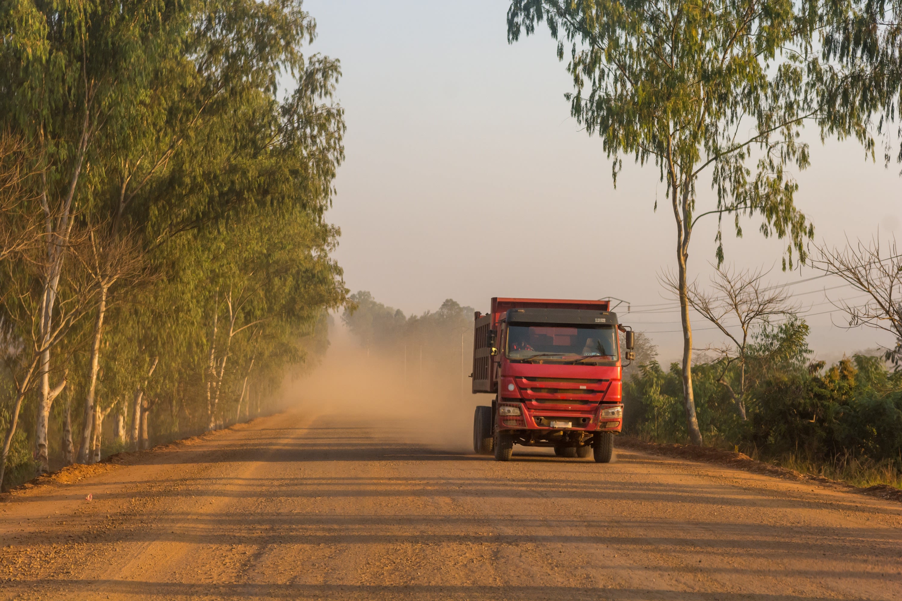 Truck rumbles along a dusty road